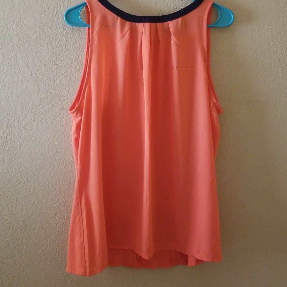 The limited sleeveless coral and blue dress shirt